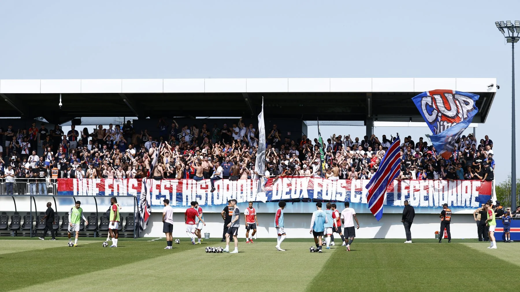 Collectif Ultras Paris supporters display a CUP flag at a PSG training session in May 2026